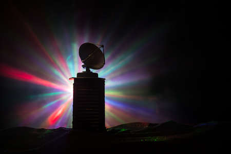 Silhouettes of satellite dishes or radio antennas against night sky. Space observatory or Air...