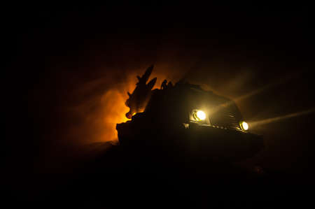 War concept. Battle scene with rocket launcher aimed at gloomy sky at night. Rocket vehicle ready to attack on cloudy war Background. Selective focusの写真素材