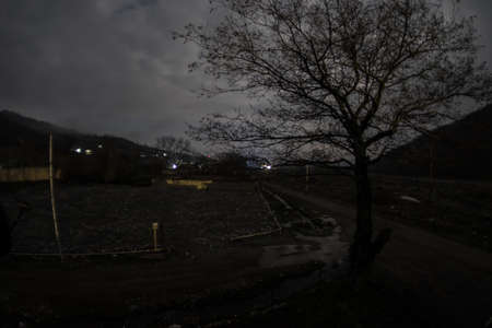 Full moon over quiet village at night. Beautiful night landscape of mountain village under the...
