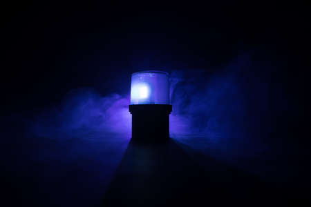 Police car blue round vintage siren in dark. Rotating retro style police siren. Selective focus