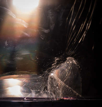 Broken led screen hit by a hammer. The concept of hatred of television, modern technology and talk shows and news. Destroyed television in living room.の写真素材