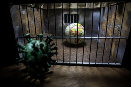 Corona virus lockdown creative concept. Planet earth trapped inside old prison. Creative artwork...