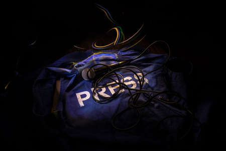 Media Journalism Global Daily News Content Concept. Blue journalist (press) vest in dark with...