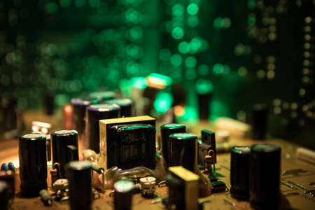 Creative concept of modern technology, inside an electronic device. Electronic circuit board close up in low key. Selective focusの写真素材