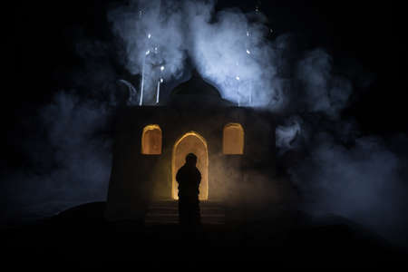 Silhouette of mosque building on toned foggy background. Ramadan Kareem background. Realistic mosque...