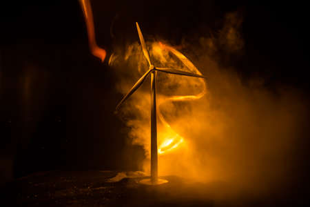 Electricity power in nature or clean energy concept. Wind Turbine producing alternative energy. Creative decoration with small miniature. Selective focusの写真素材