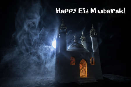 A realistic Mosque miniature with windows at night. Festive greeting card, invitation for Muslim holy month Ramadan Kareem. Selective focusの写真素材