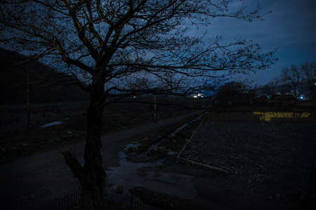 Full moon over quiet village at night. Beautiful night landscape of mountain village under the...