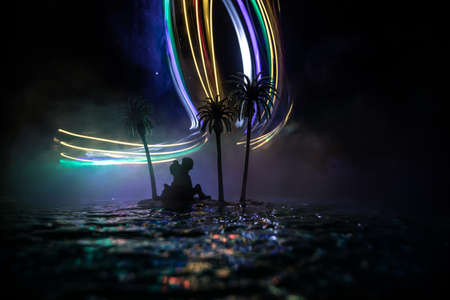 Romantic night scene. Fantasy night landscape with little island with palms and romantic couple...