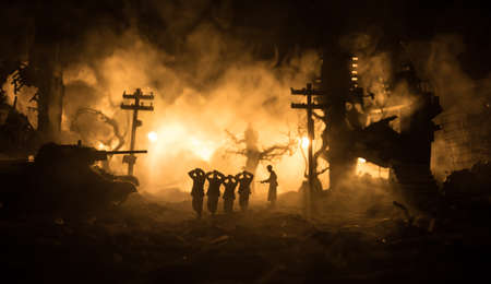 Military silhouettes fighting scene on war fog sky background. A German soldiers raised arms to surrender. Plastic toy soldiers with guns taking prisoner the enemy soldier. Selective focusの写真素材