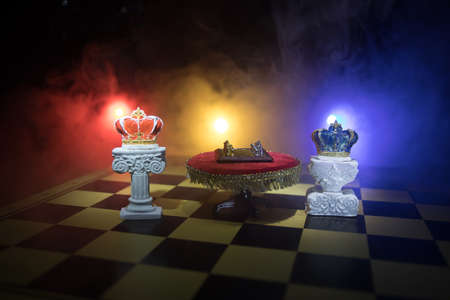 Beautiful Crown on chessboard. chess board game concept of business ideas and competition and strategy ideas concept. Chess figures on a dark background with smoke and fog. Selective focusの写真素材