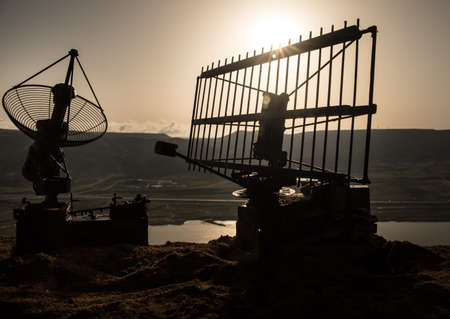 Space radar antenna on sunset. Silhouettes of satellite dishes or radio antennas against night sky. Creative artwork decoration. Selective focusの写真素材