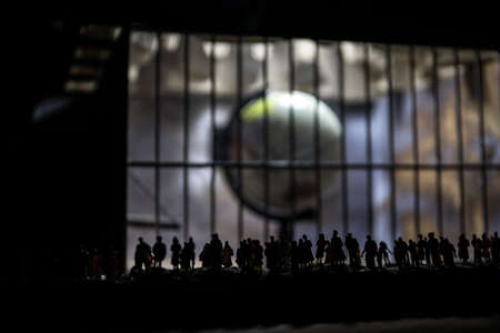 Corona virus lockdown creative concept. Crowd looking on Planet earth trapped inside old prison....