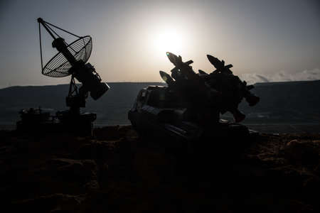 Creative artwork decoration. Silhouette of mobile air defense truck with radar antenna during...