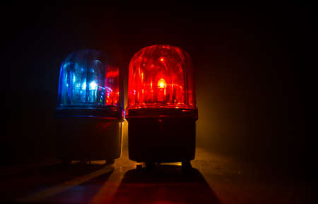 Police car blue and red round vintage siren in dark. Rotating retro style police siren. Selective focusの写真素材