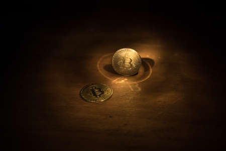 Golden Bitcoin on dark backround. New virtual money. Crypto currency. Creative artwork decoration. Selective focusの写真素材