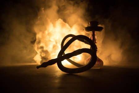 Shisha Concept. Hookah hot coals on shisha bowl with black background. Stylish oriental shisha with colorful lights. Selective focusの写真素材