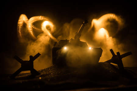 War Concept. Armored vehicle silhouette fighting scene on war foggy sky background at night....