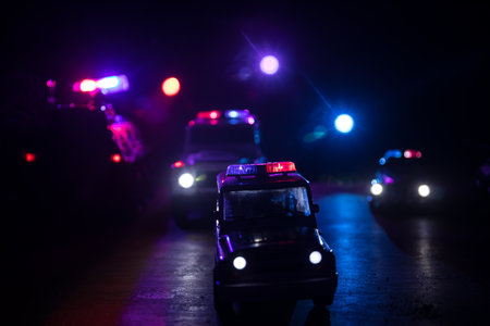 Police cars at night. Police car chasing a car at night with fog background. 911 Emergency response...