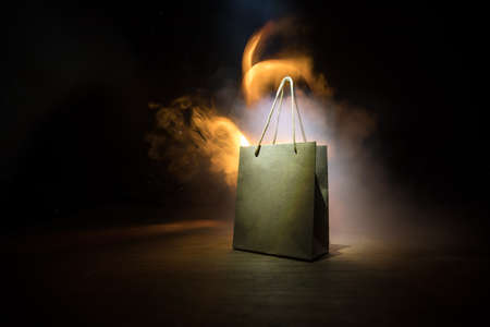 Shopping concept. Brown shopping bag with handles placed on dark desktop. Selective focusの写真素材