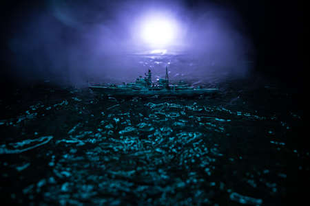 War concept. Night battle scene at sea. Dramatic toned clouds effect. Silhouette of the battle ship...