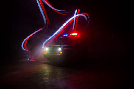 Police car chasing a car at night with fog background. 911 Emergency response police car speeding to...