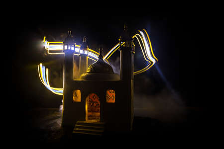 A realistic Mosque miniature with windows at night. Festive greeting card, invitation for Muslim holy month Ramadan Kareem. Selective focusの写真素材