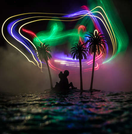Romantic night scene. Fantasy night landscape with little island with palms and romantic couple...