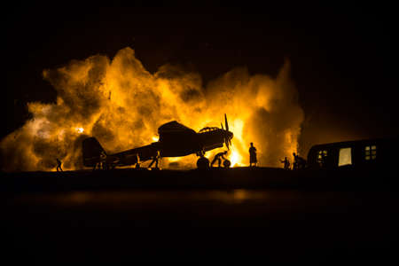 German Junker (Ju-88) night bomber at night. Artwork decoration with scale model of jet-propelled plane in possession. Toned foggy background with light. War scene. Selective focusの写真素材