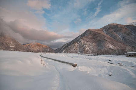 Majestic sunset in the winter mountains landscape. Dramatic sky. Azerbaijan nature. Shaki