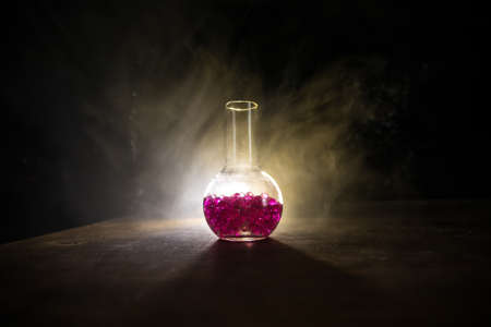 Pharmacy and chemistry theme. Test glass flask with solution in research laboratory. Science and...