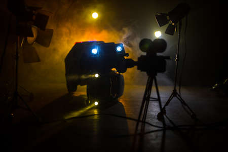 Action movie concept. Police cars and miniature movie set on dark toned background with fog. Police car chasing a car at night. Scene of crime accident. Selective focusの写真素材