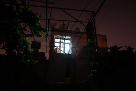Old house with a Ghost in the forest at night or Abandoned Haunted Horror House in fog. Old mystic...