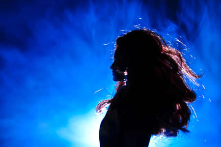 Silhouette of a female face on a light background. SIlhouette of a lonely doll with long hair at...