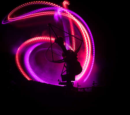 Silhouettes of satellite dishes or radio antennas against night sky. Space observatory or Air defense radar over dramatic night sky. Creative artwork decoration. Selective focusの写真素材