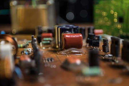 Creative concept of modern technology, inside an electronic device. Electronic circuit board close up in low key. Selective focusの写真素材