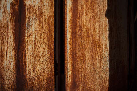old rusty metal background or texture in dark room with light. Close up. Long exposure shot