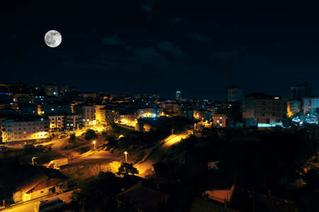 Full moon over the city at night, Istanbul, Turkey. Big full moon shining bright over buildings....