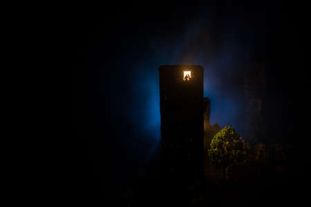 concept of loneliness, in the form of a silhouette of woman and man in a city window at night. Symbol of expectation, dreams and destinies. Creative decoration with City miniature. Selective focusの写真素材