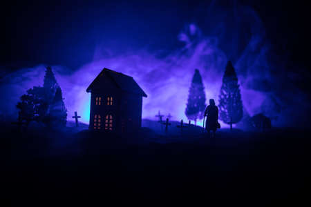 Silhouette of old woman with a cane walking at cemetery at night. Horror Halloween concept. Artwork...