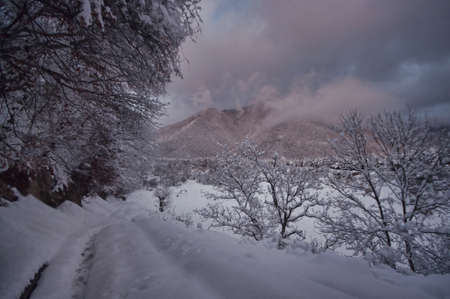 Majestic sunset in the winter mountains landscape. Dramatic sky. Azerbaijan nature. Shaki