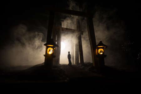 Creative artwork decoration. Abstract Japanese style wooden tunnel at night. Night scene in fantasy forest. Selective focusの写真素材