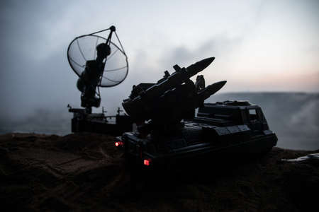 Creative artwork decoration. Silhouette of mobile air defense truck with radar antenna during...