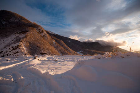 Majestic sunset in the winter mountains landscape. Dramatic sky. Azerbaijan nature. Shakiの写真素材