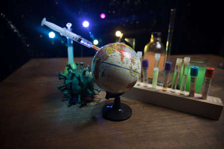 virus Vaccine concept with syringe and green virus novel miniature. Vaccine Concept of fight against...