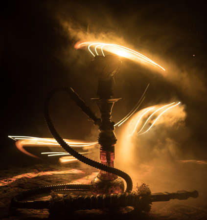 Shisha Concept. Hookah hot coals on shisha bowl with black background. Stylish oriental shisha with...