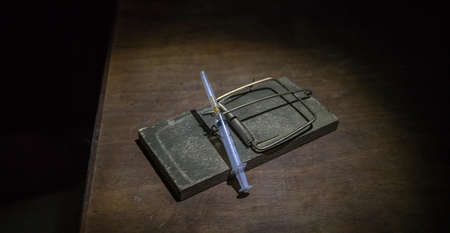 Corona virus Vaccine concept with syringe on mousetrap. Abstract green Corona virus novel miniature....
