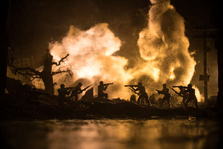 War Concept. Military silhouettes fighting scene on war fog sky background, World War Soldiers Silhouette Below Cloudy Skyline At night. Battle in ruined city. Selective focusの写真素材