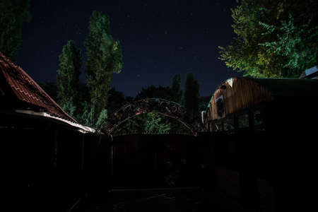 Old house with a Ghost in the forest at night or Abandoned Haunted Horror House in fog. Old mystic...