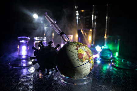 virus Vaccine concept with syringe and green virus novel miniature. Vaccine Concept of fight against...